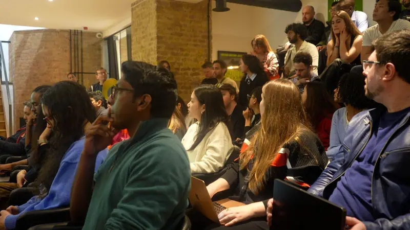 An Open House audience listening to a talk